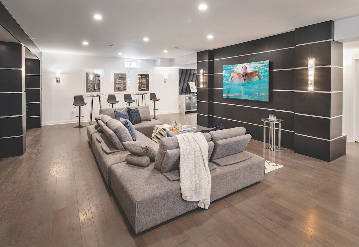 Basement home theater with central TV and ample couch space