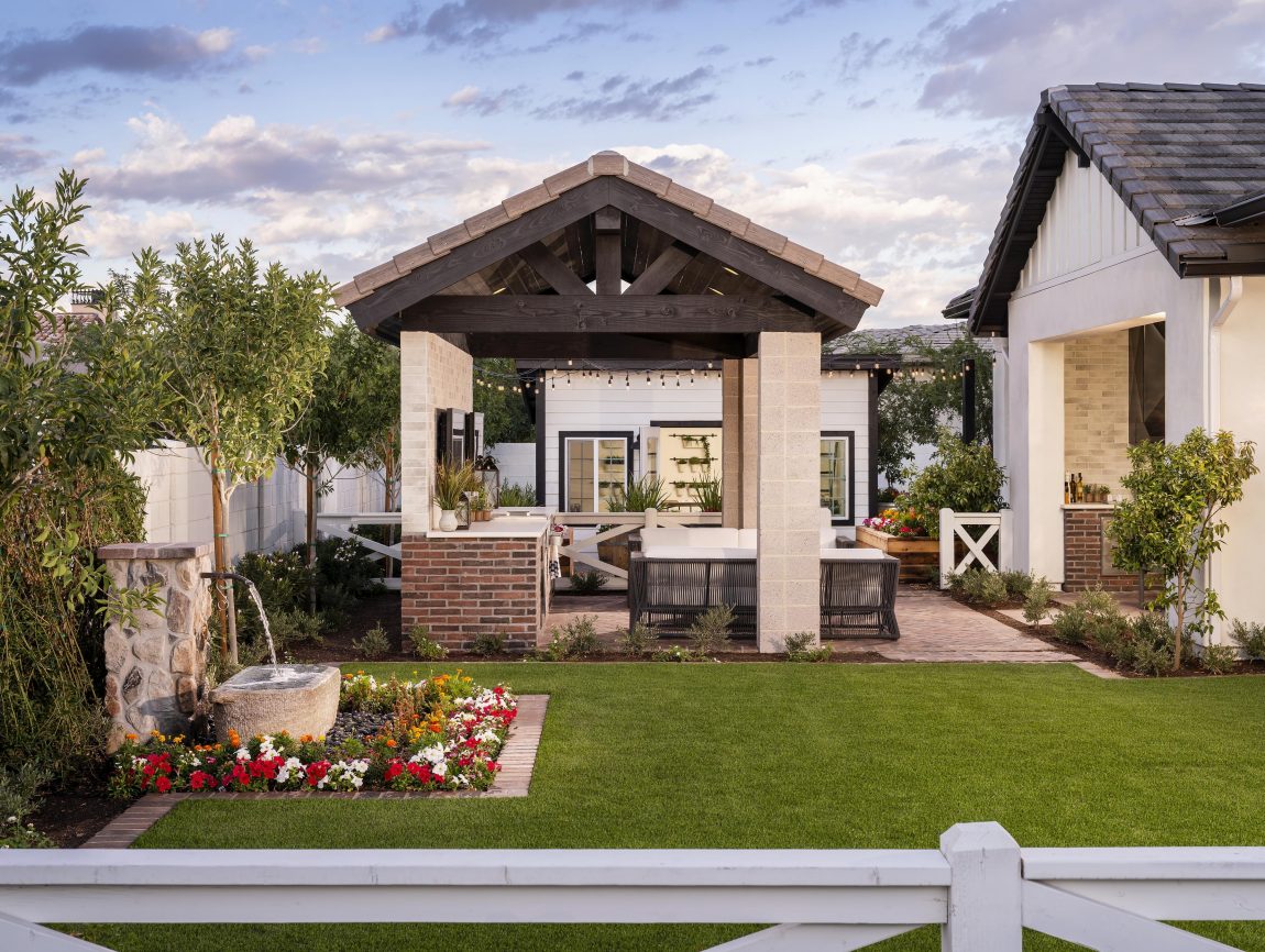 Luxury outdoor entertainment space with TV and couches