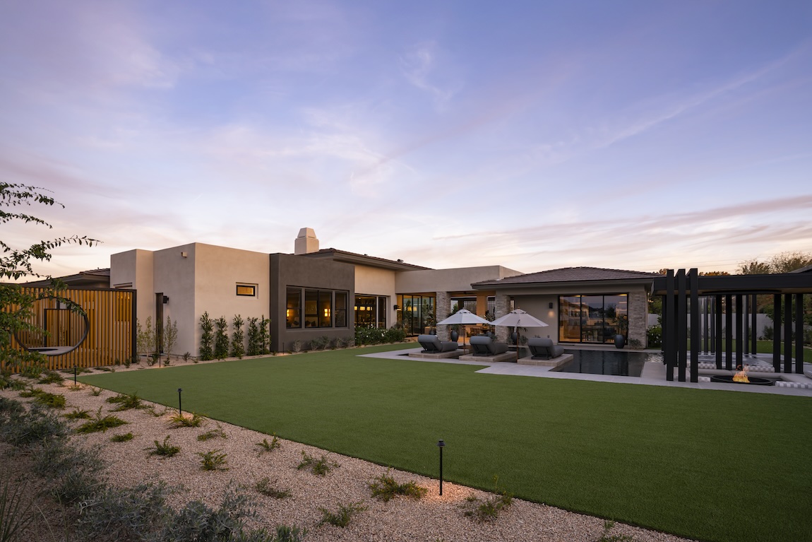 exterior of home with landscaping features and pool