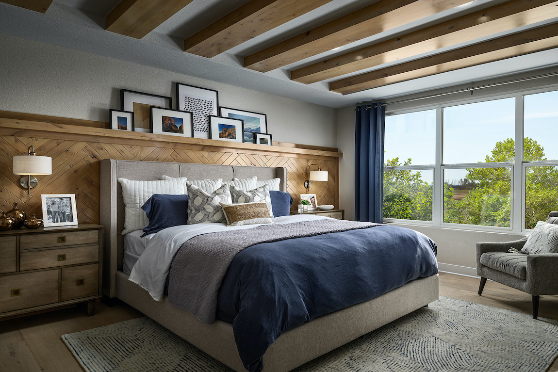 Bedroom with wooden beams, wood wall detail and blue comforter