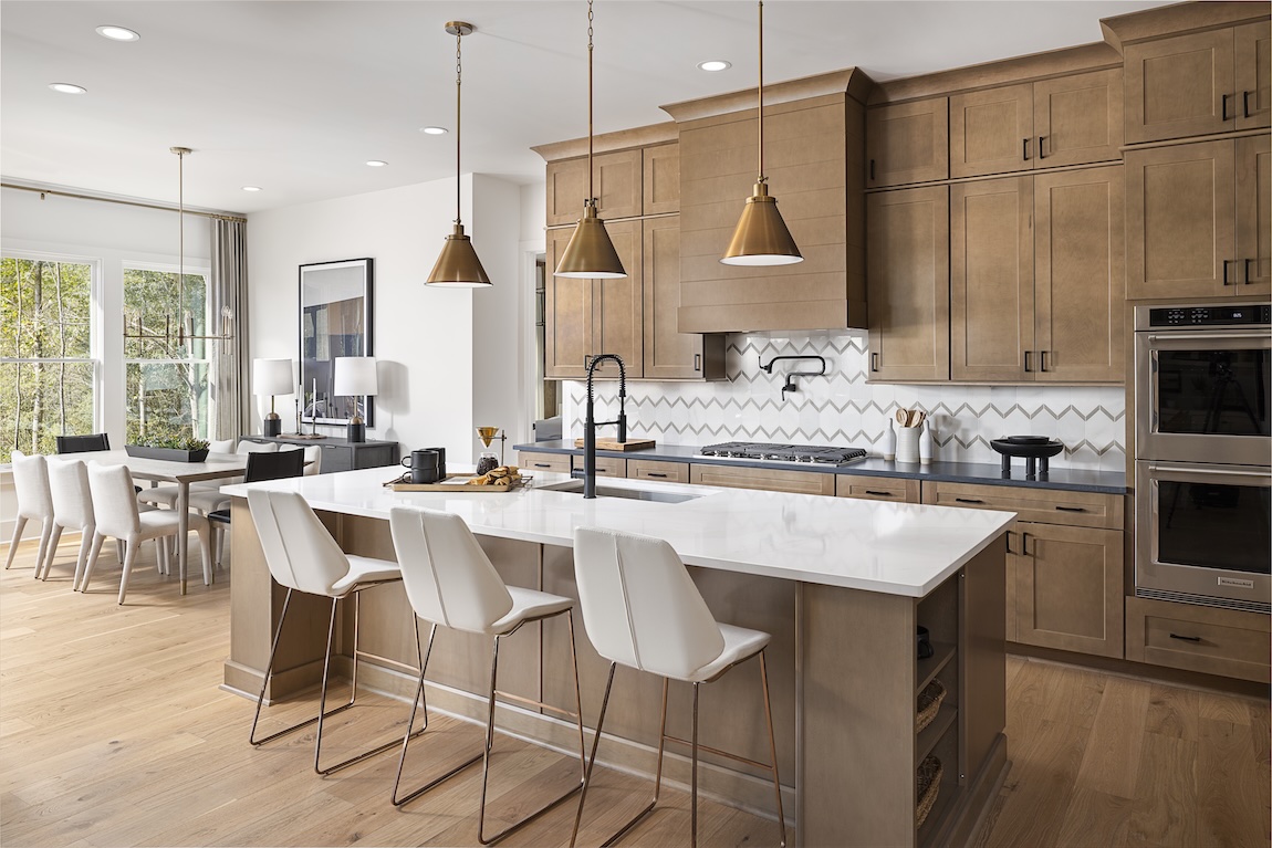 modern kitchen with wooden cabinetry and marble countertop