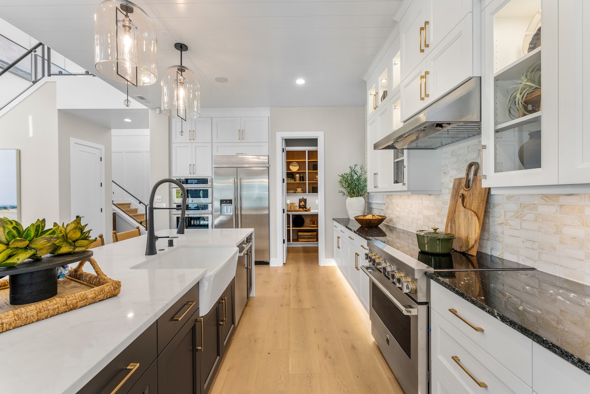 modern kitchen with white cabinets and toe kick lighting