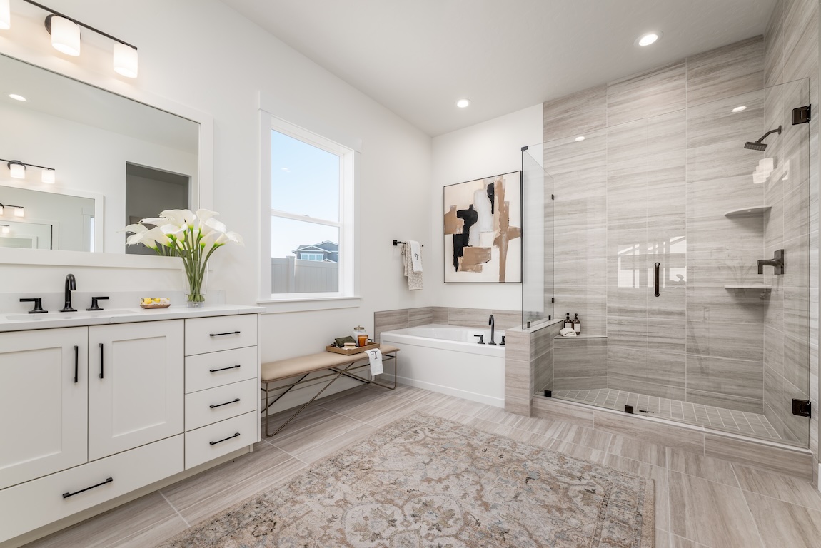 primary bathroom with tile flooring transitioning into the large shower