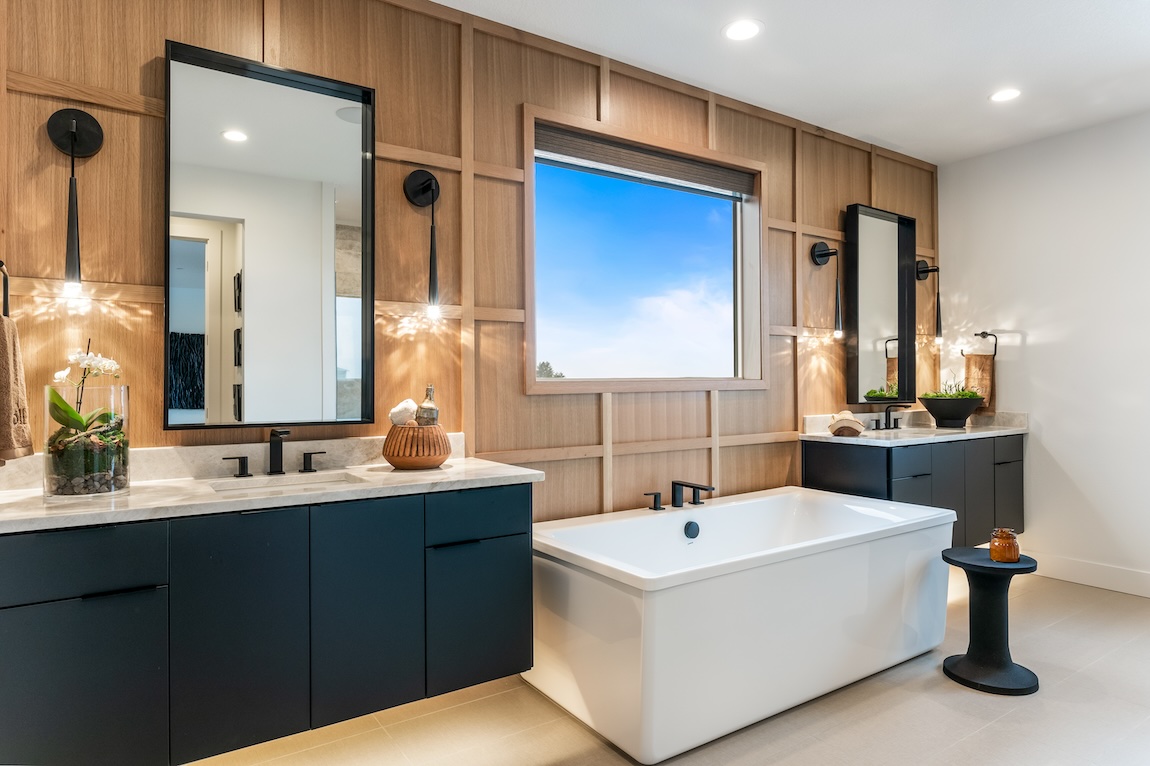 bathroom with dual vanities featuring floating cabinets