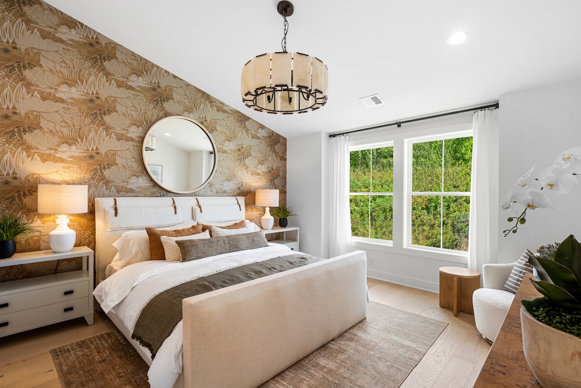 Bedroom with brown floral accent wall and bedside flowers