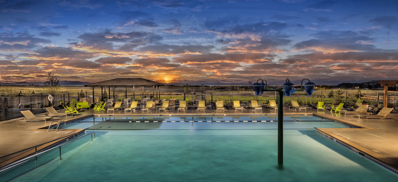Pool overlooking a sunset the Toll Brothers at Inspiration community.