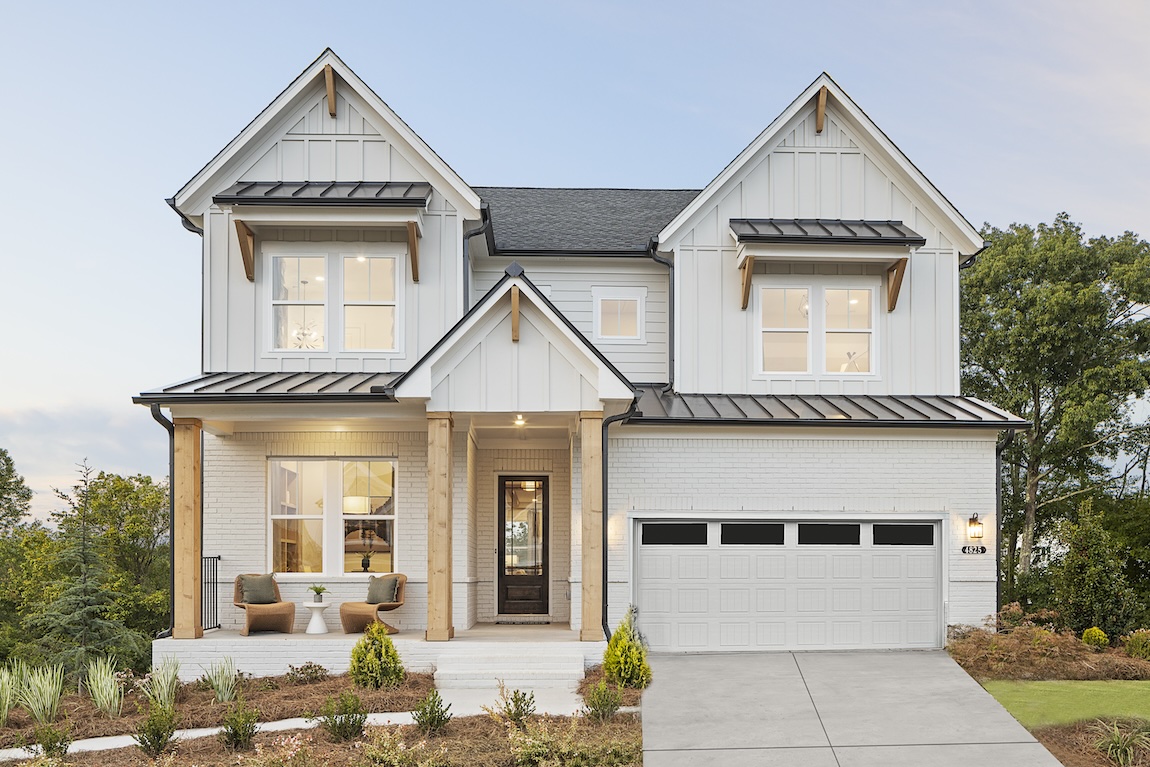 Modern farmhouse exterior of a quick move-in home in Canton, GA with front porch and black trim