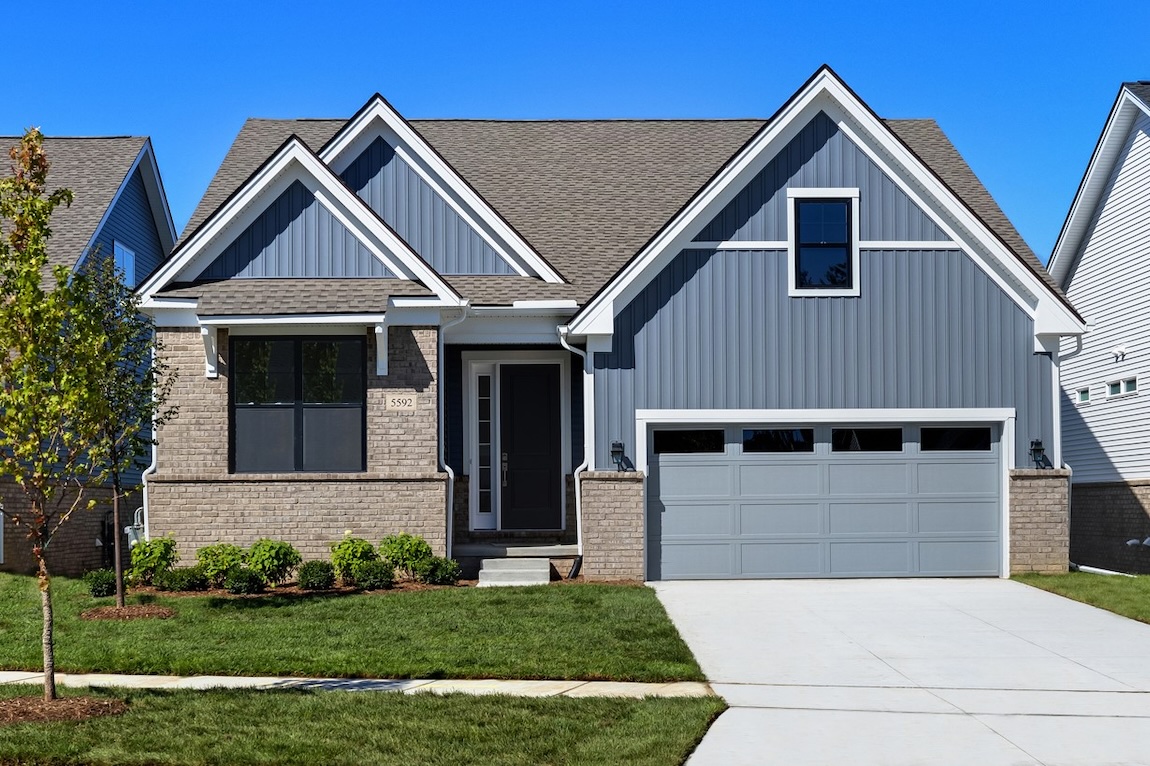 Traditional craftsman exterior of a quick move-in home in West Bloomfield Township, MI, with brick accents