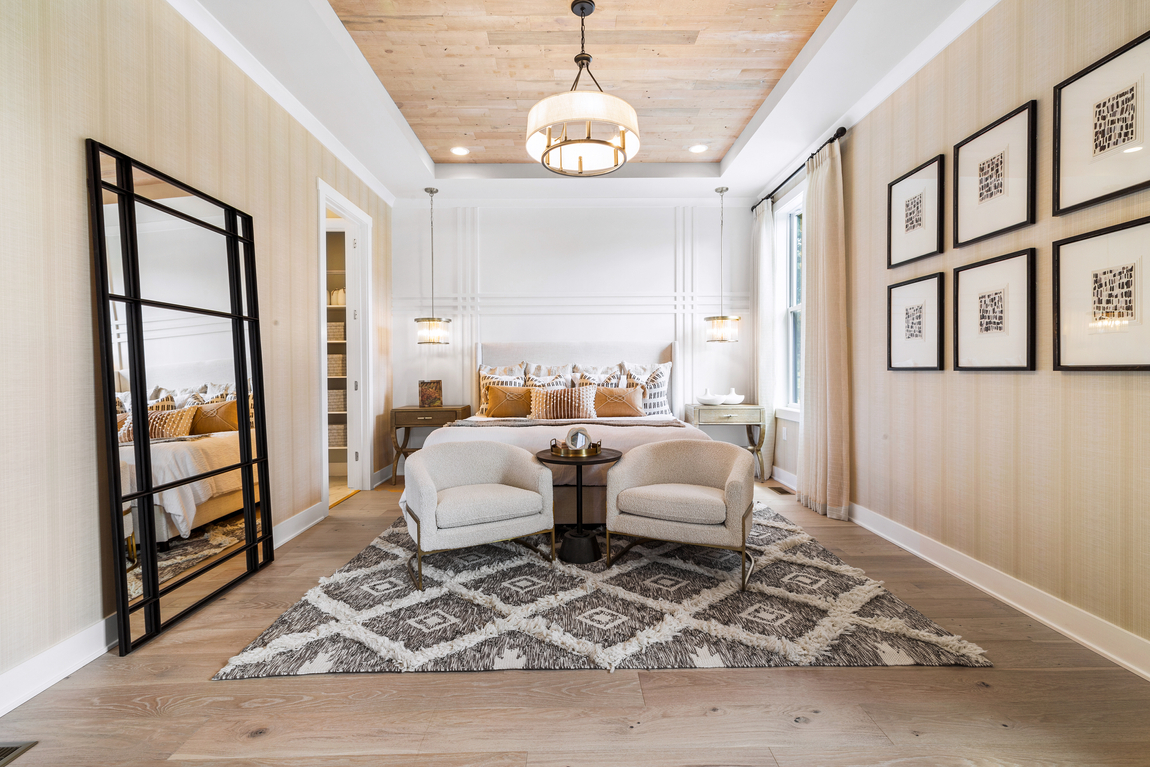 Bedroom with tan flooring and ceiling and queen bed. 