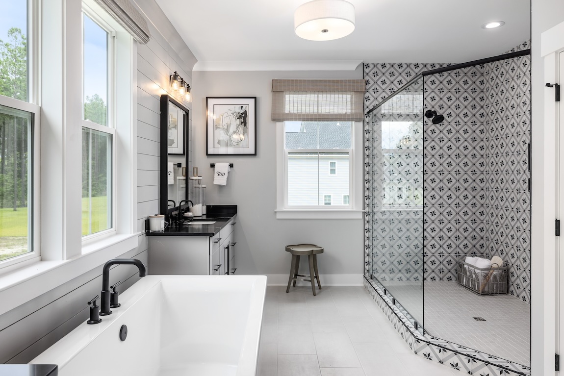 luxury bathroom featuring walk-in shower with ornate wall tile design