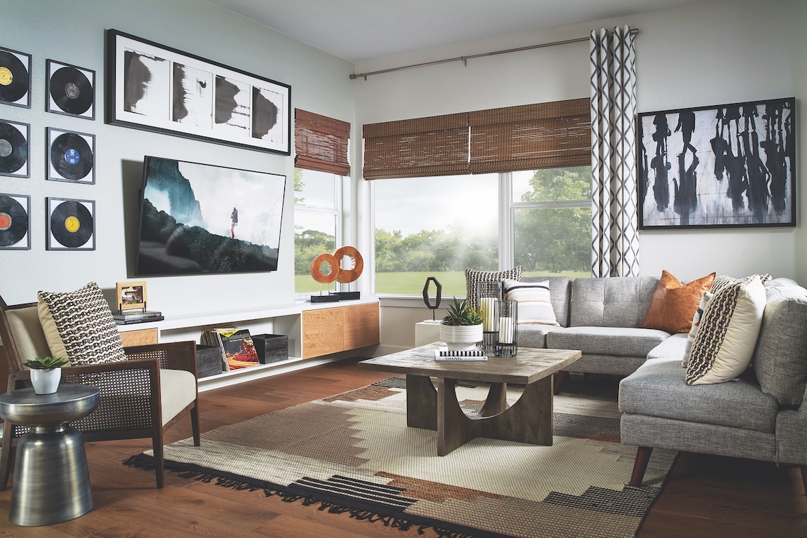 Flex room with vinyl records hanging on wall and music elements with wicker chairs