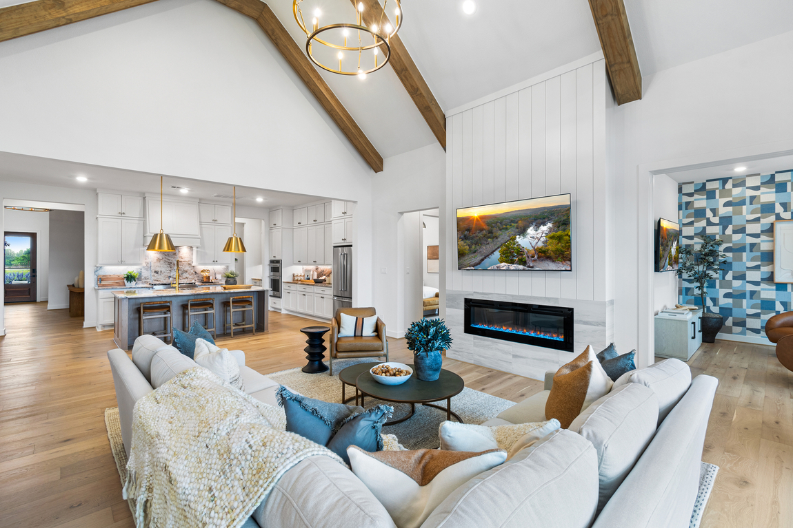 Living room with wood beam ceilings and white sofa. 