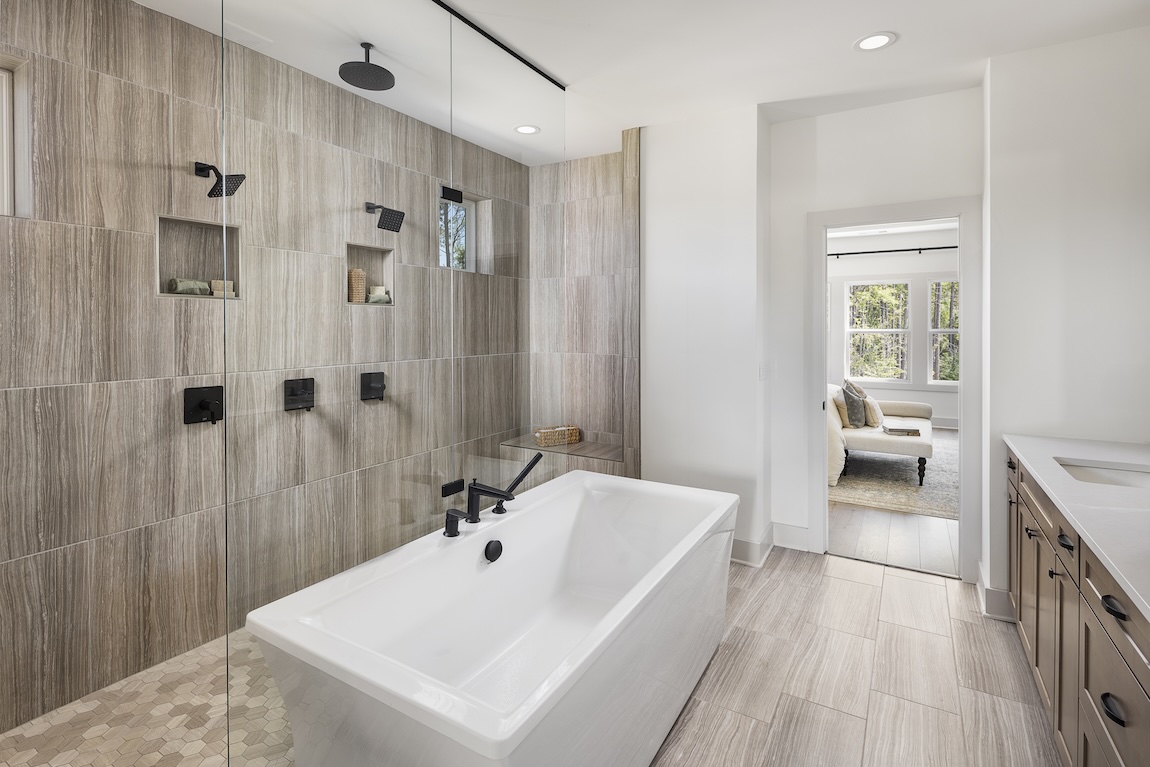 luxury bathroom with spacious walk-in shower highlighted by wall tile design