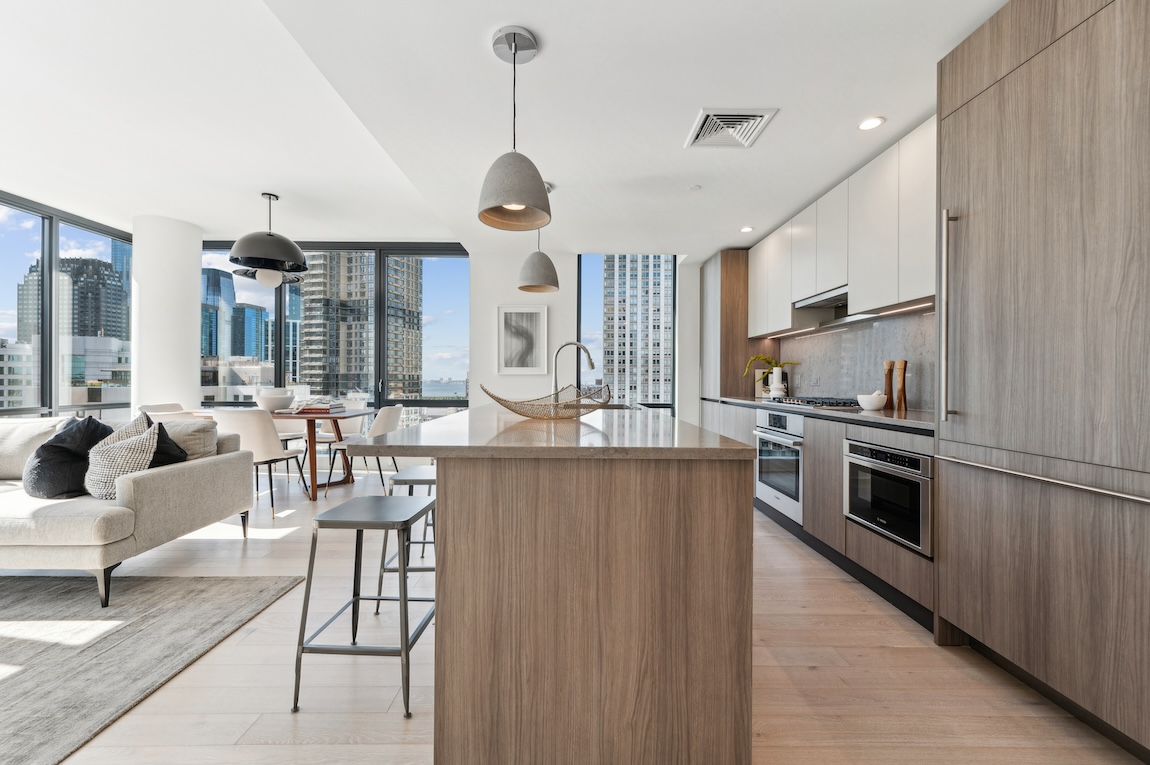 151 Bay Street luxury high-rise features kitchen with wooden accents and city views. 