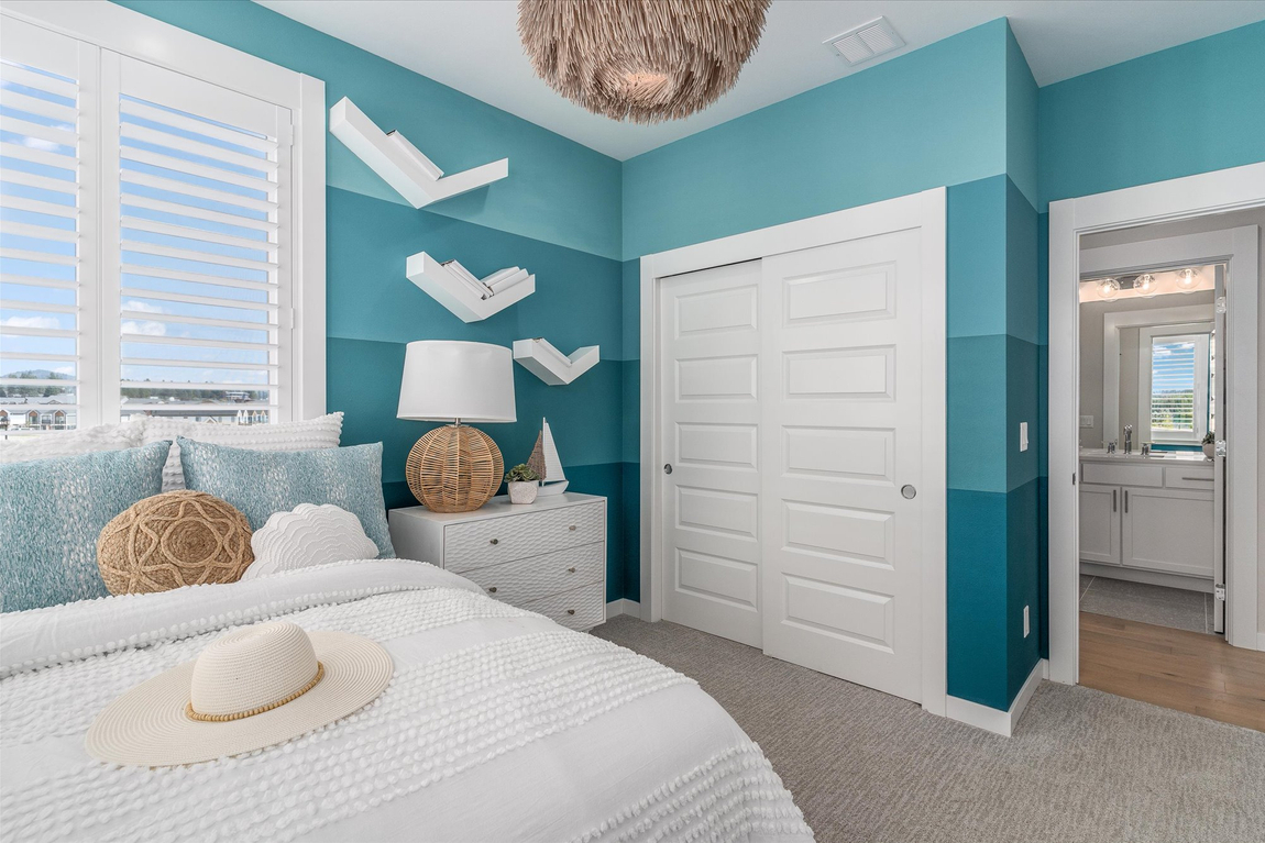 bedroom featuring mutli-color blue wall