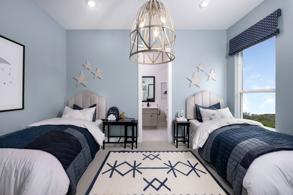 kids bedroom design featuring light blue walls and blue accent decor