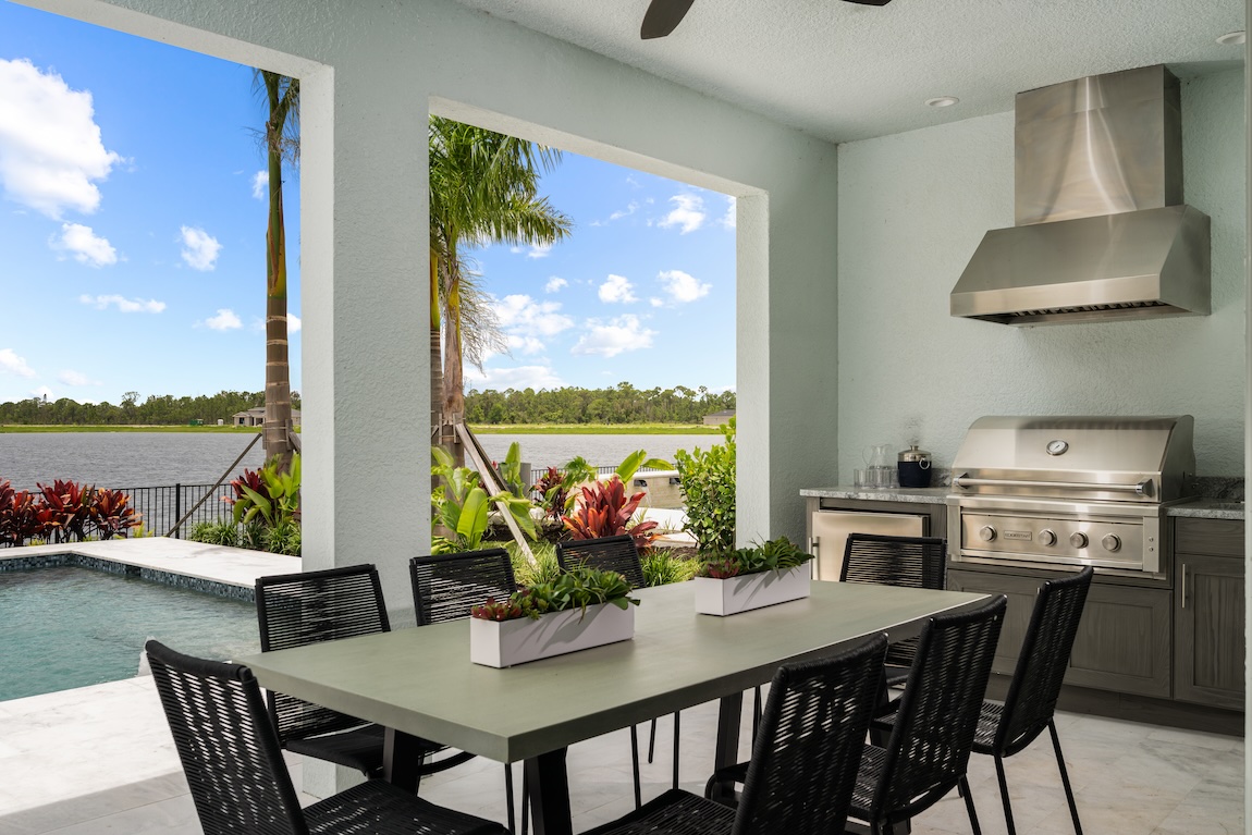 Florida covered outdoor dining area with ceiling fan and pool view