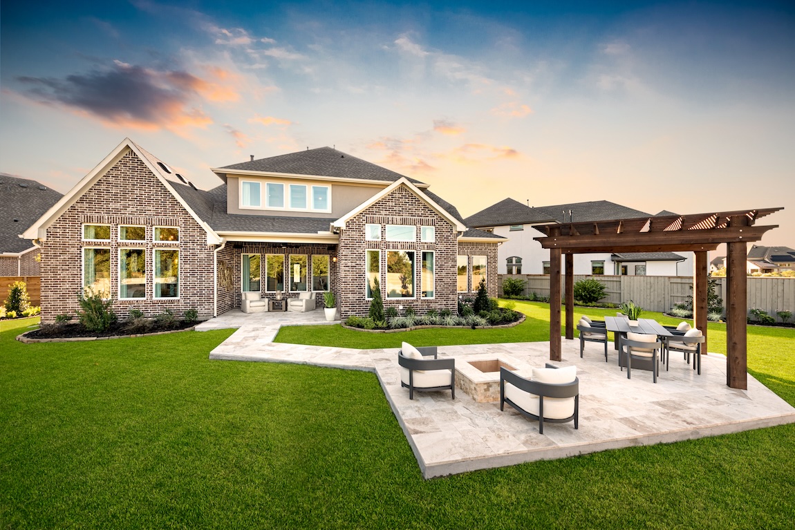 luxe backyard featuring patio highlighted by fire pit, dining area, and pergola in Manvel, Texas