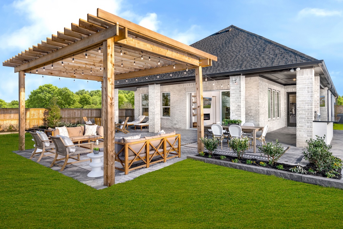 Modern outdoor dining setting highlighted by string lights and pergola