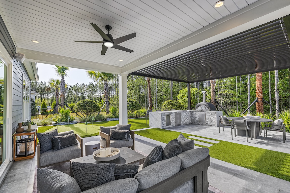 Outdoor living space featuring dining table and in large patio with gray accents