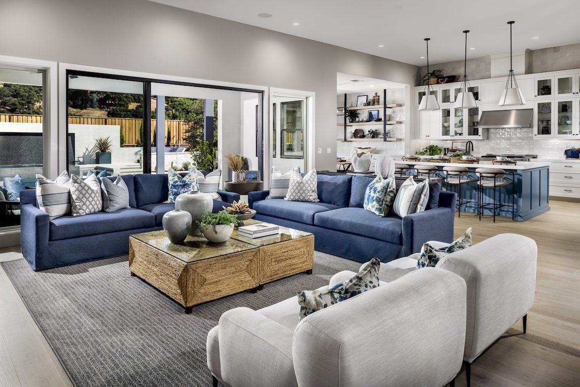 open-concept blue living room highlighted by eye-catching couch color