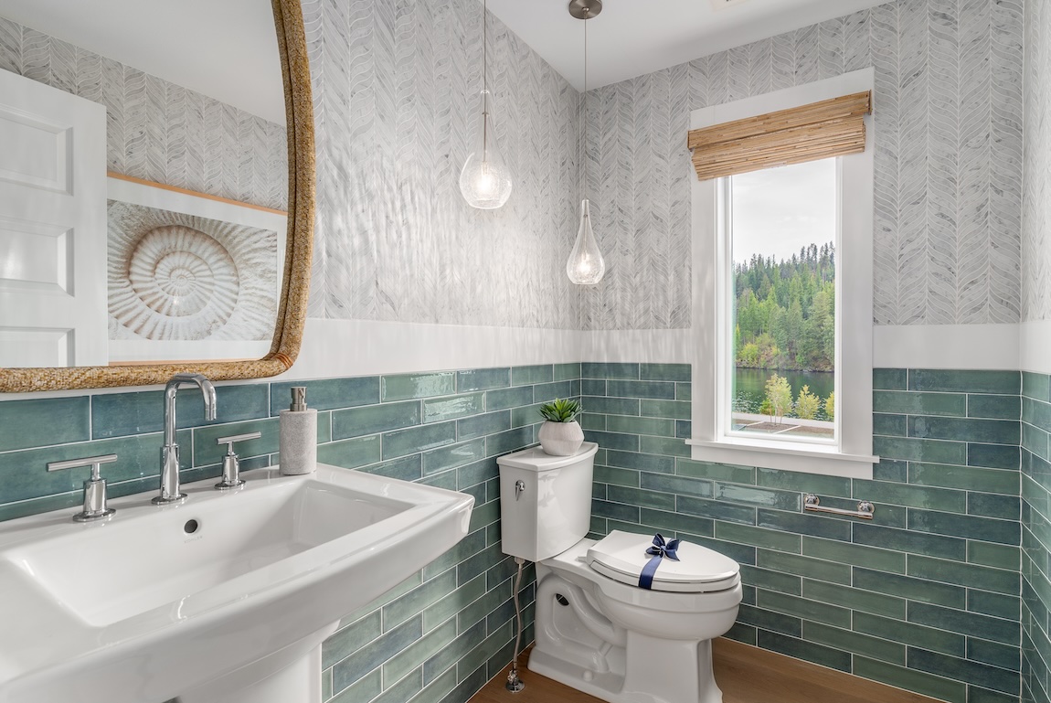 powder room with green subway tile