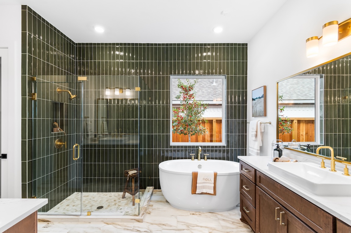 luxe primary bathroom with green tile accent wall