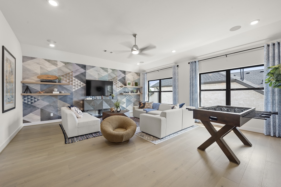 playful loft featuring energetic wallpaper and blue accents