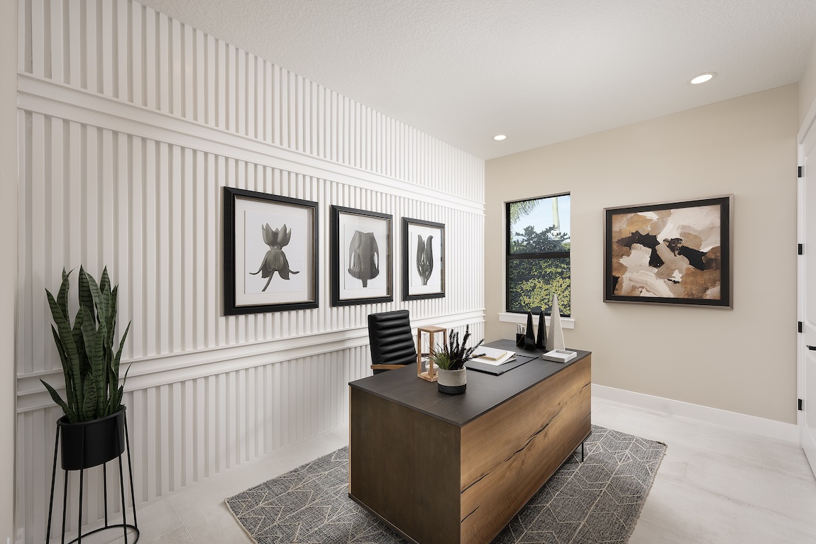 home office with accent wall featuring fluted panel design