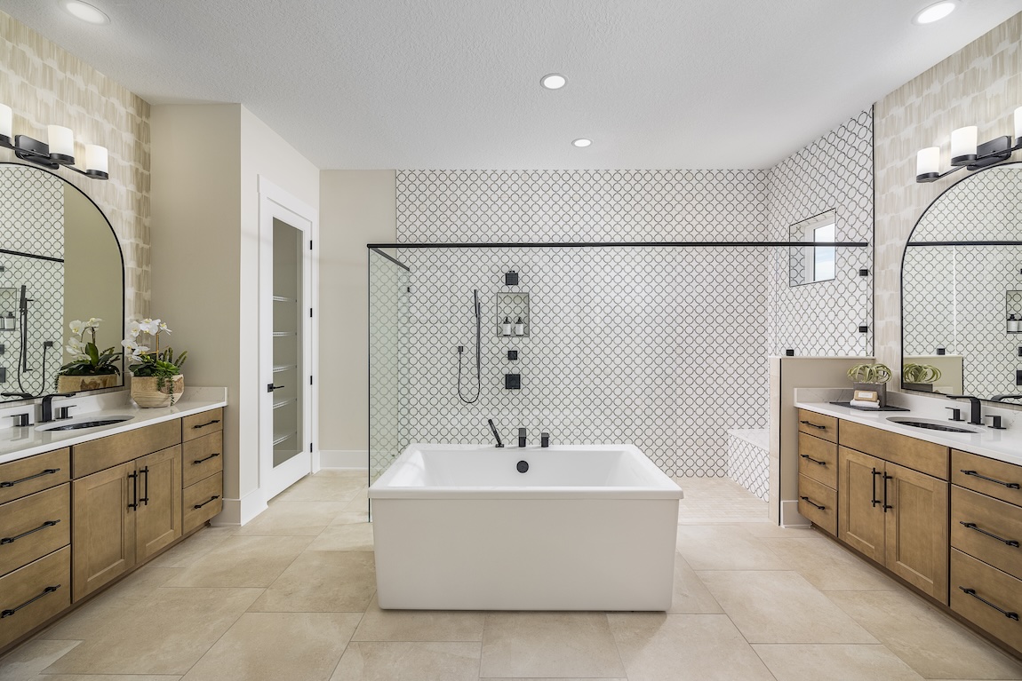 modern primary bathroom featuring central freestanding bathtub and walk-in shower