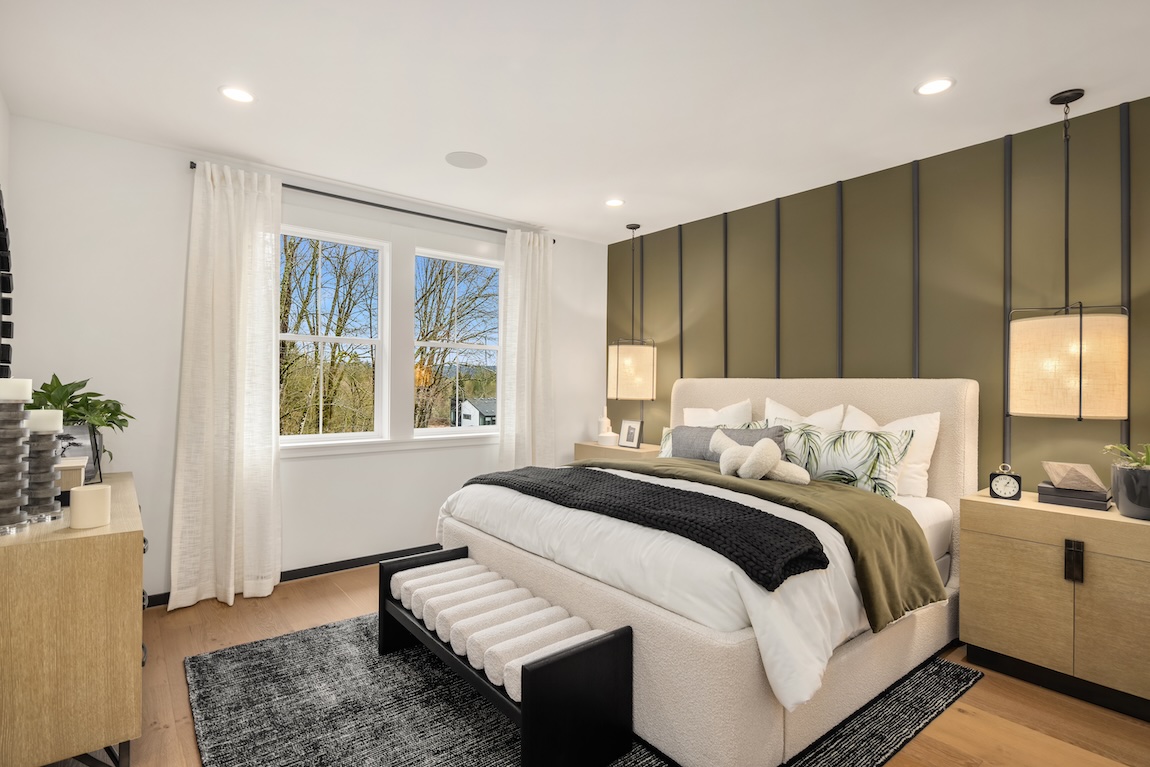 modern bedroom featuring green accent wall