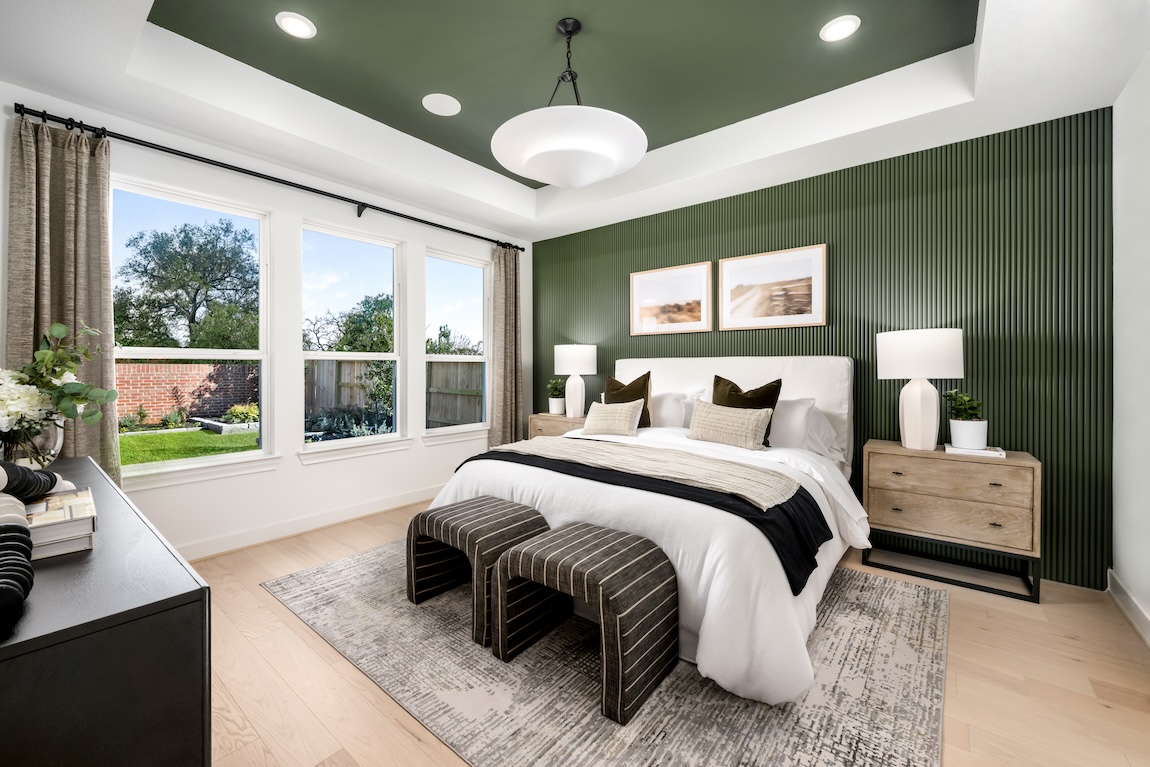 first-floor bedroom design featuring matching green accent wall and ceiling