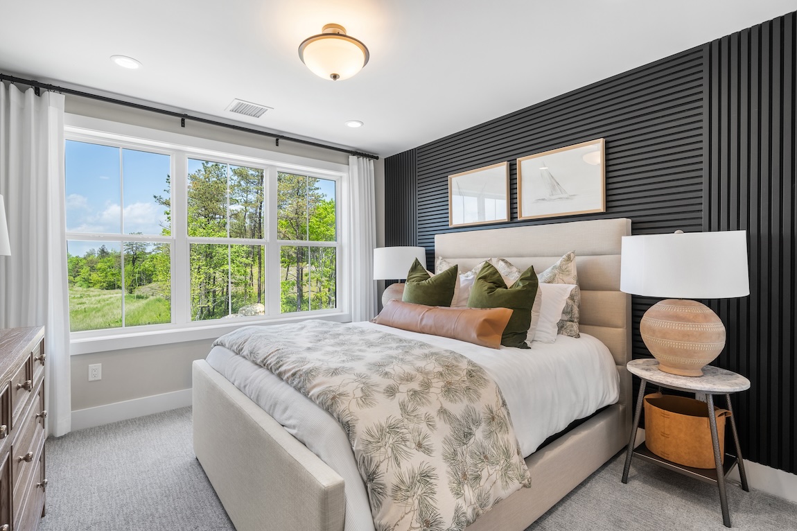 secondary bedroom with black fluted panel accent wall