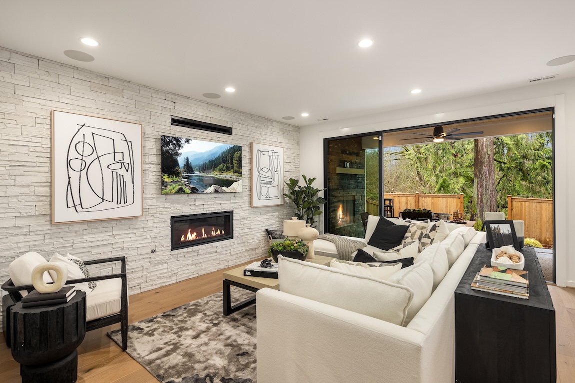 Great room featuring stone accent wall and modern fireplace insert