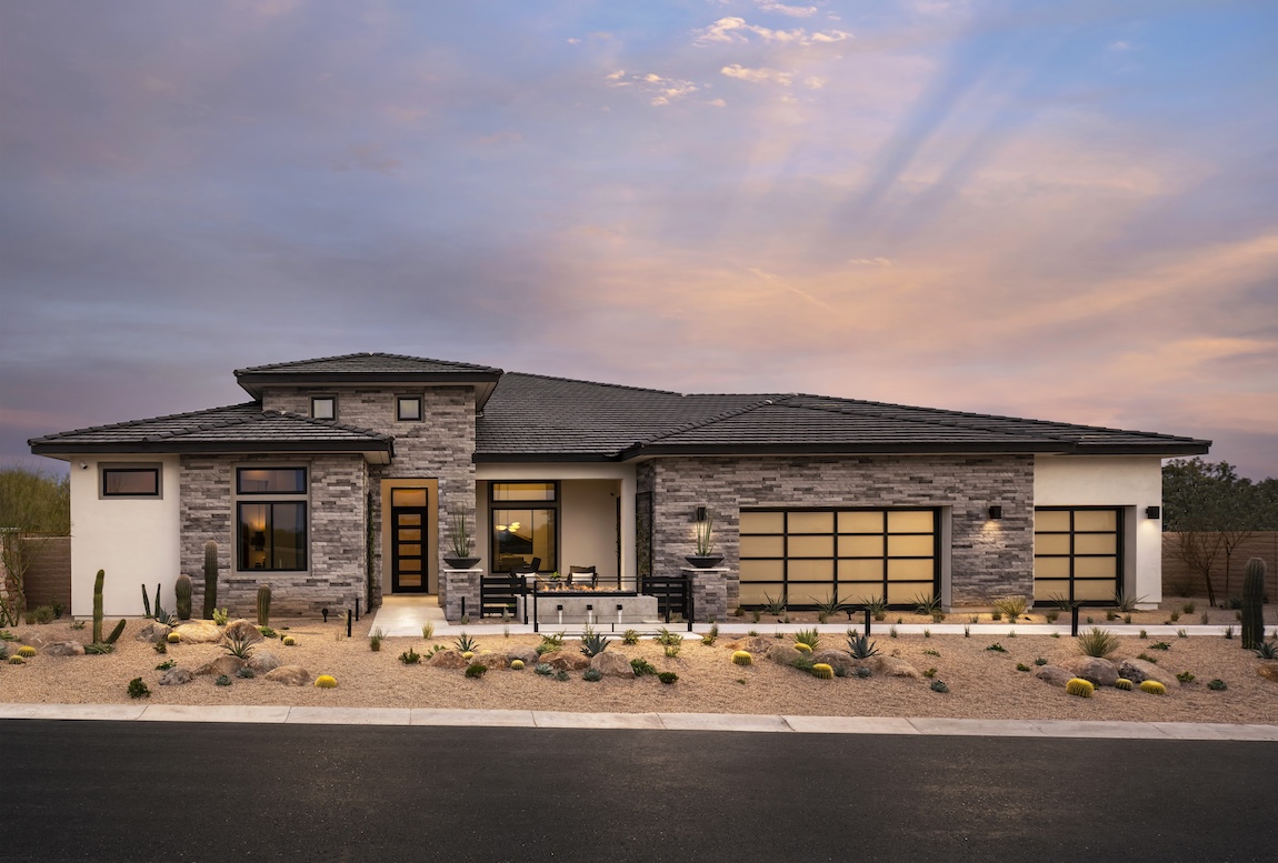 Stone exterior of single-family home by Toll Brothers with desert landscaping in Sedona, Arizona. 