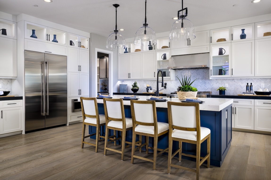 impressive high-contrast kitchen featuring blue herringbone backsplash and island