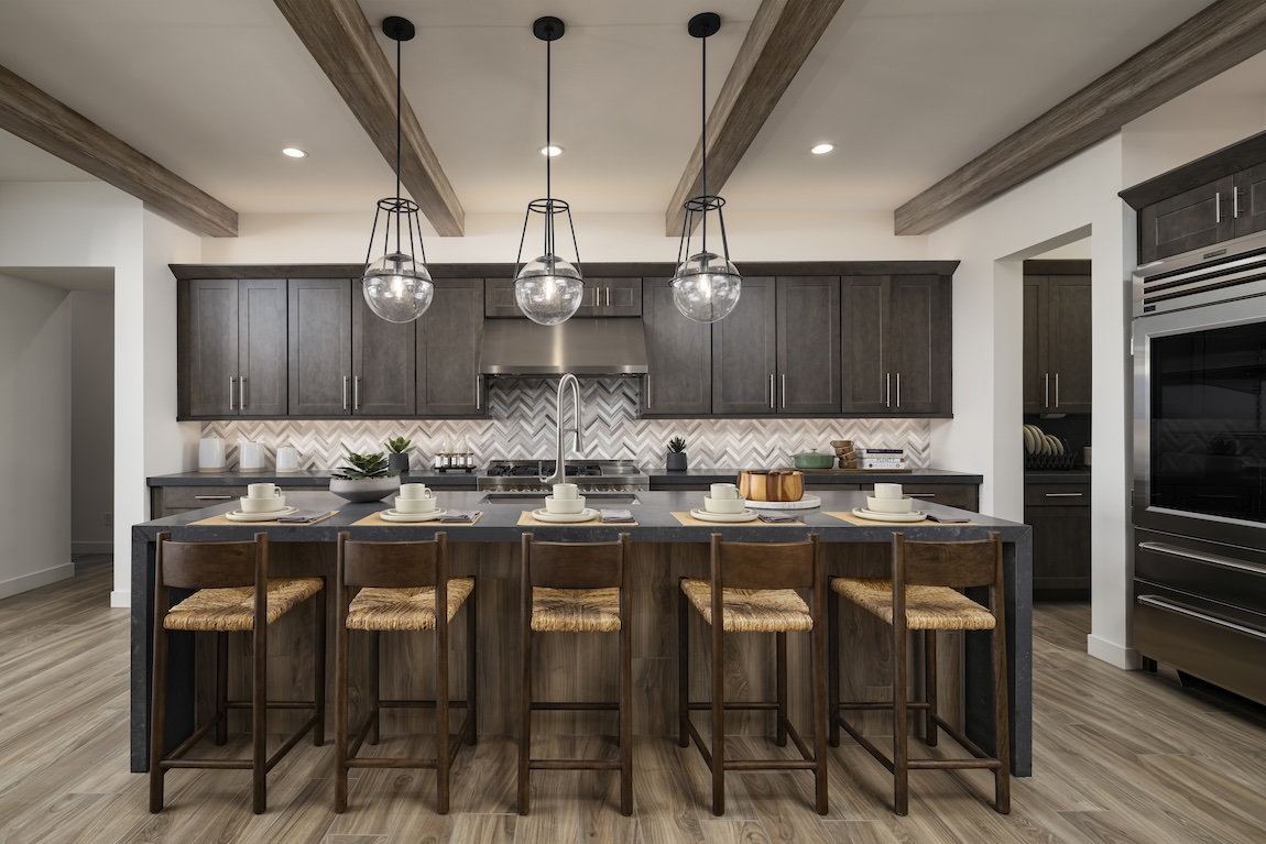 Luxurious modern farmhouse kitchen with globe pendant lights and wood beam ceiling accents