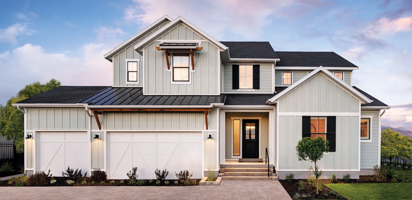 Luxury home design featuring white siding and board and batten.