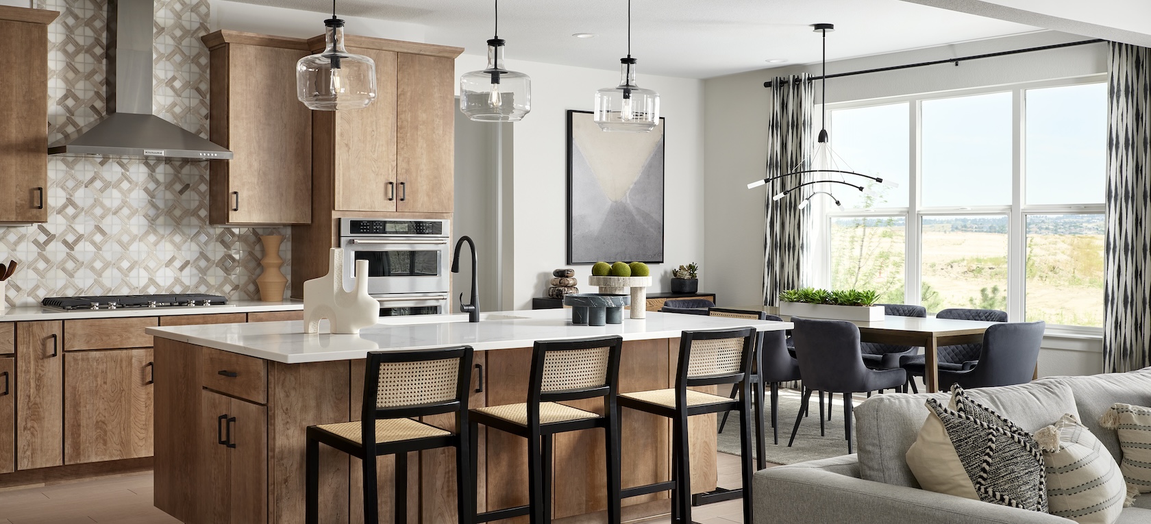 Luxury kitchen design with wood accents and raton island chairs